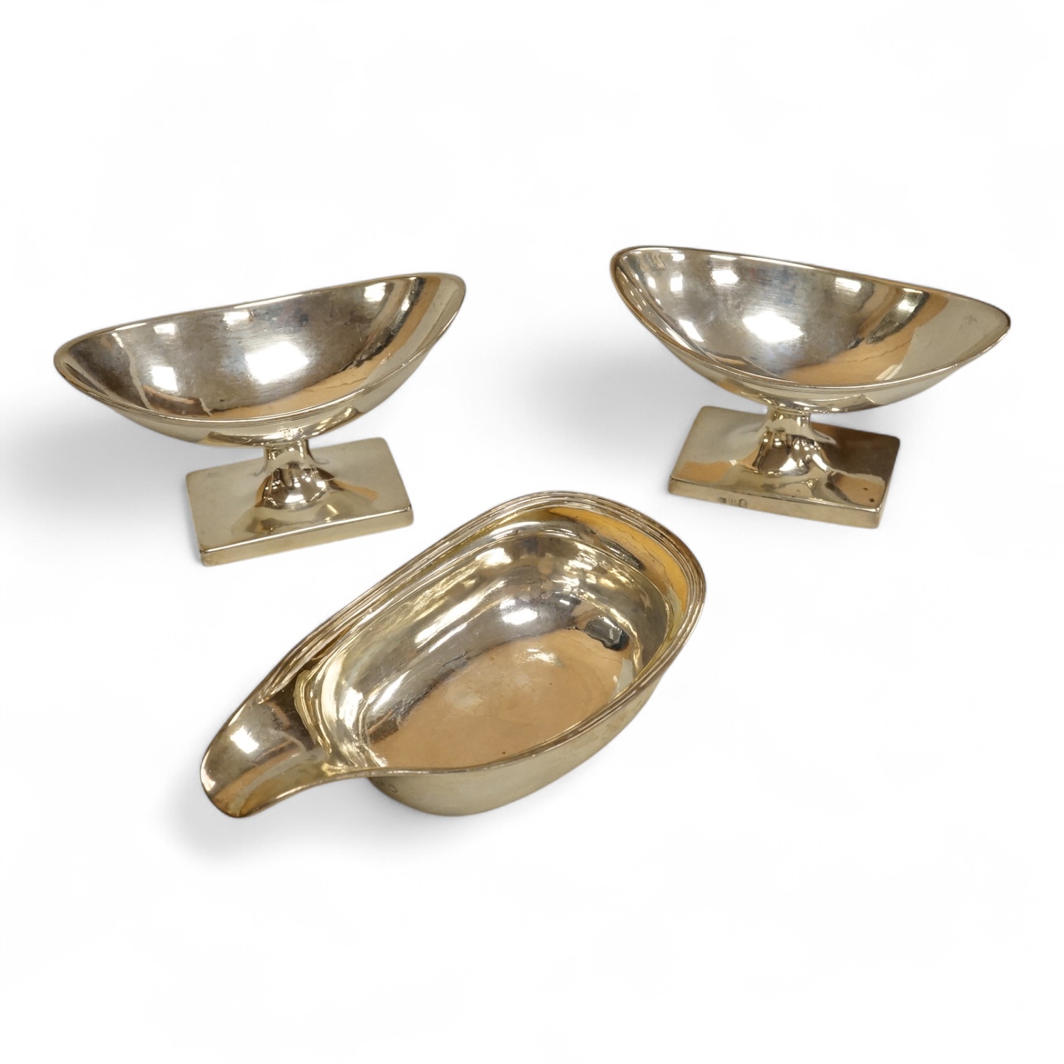 A George III silver pap boat, maker ?? and EB, London 1812, length 12.1 cm, together with a pair of Georgian Scottish silver boat shaped pedestal salts, maker RG, gross weight 7oz.